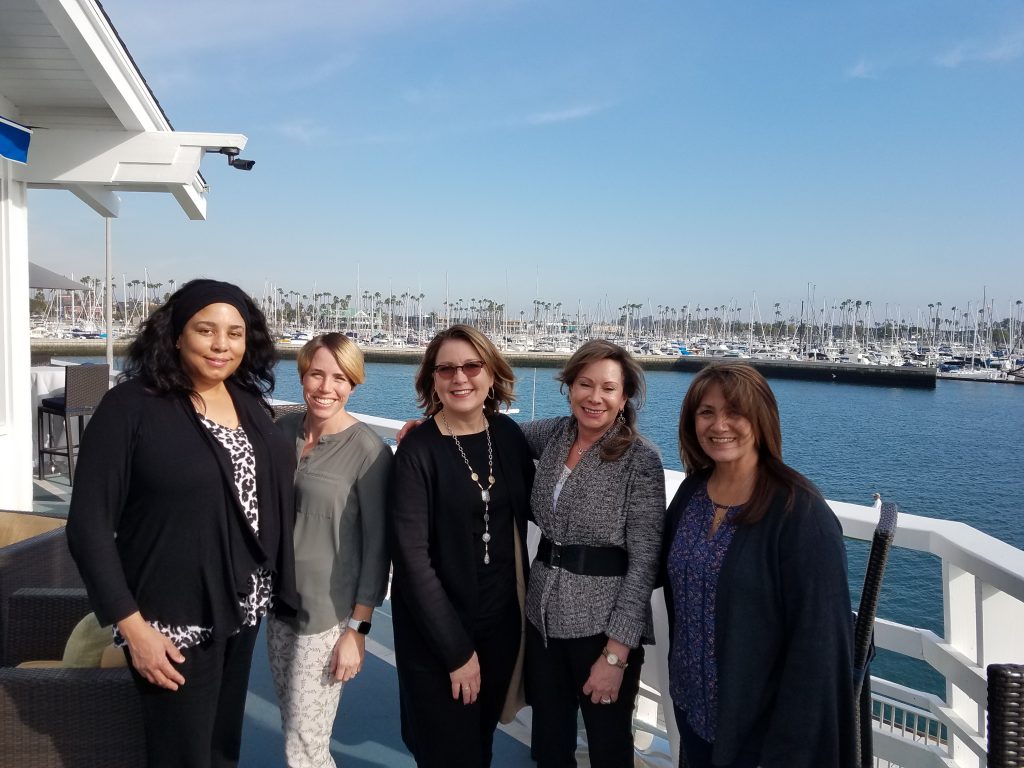 Photo of Keynae Agnew, Jamie Benson, Carla Campbell, Leslie Marell and Dorothy Gosnell outdoors by a pier